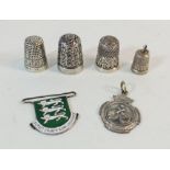Four silver thimbles and two silver badges