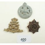 Three 'plastic issue' cap badges