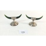A pair of silver and dark green jade horn form knife rests, Birmingham 1910 by G E Walton & Co