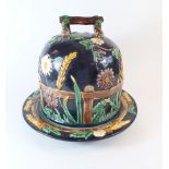 A Victorian Majolica George Jones cheese dish and cover, decorated 'Daisy and Fence' pattern on a