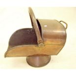 A copper helmet form coal scuttle