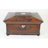 An early 19th century rosewood sarcophagus form tea caddy with mother of pearl inlay and fitted