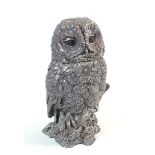 A filled silver model of an owl on a branch, marked CA, 12cm
