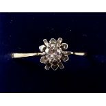 An 18ct gold solitaire diamond ring in flower form setting, size O/P