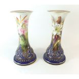 A pair of rare Royal Worcester vases painted tropical flowers within deep blue and gilt borders by