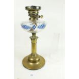 A Victorian cut glass oil lamp with blue flashed and cut decoration plus a later globe shade