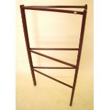 An early 20th century mahogany folding towel rail