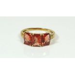 A 9 carat gold three stone topaz ring, size N