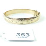 A 9 carat gold and metal core bangle