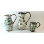 Three 1950's Glyn Colledge jugs decorated with leaves and flowers, all signed, 23, 20 and 11.5 cm