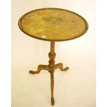 An early 19th century painted wine table with floral decoration to top on turned column and triple