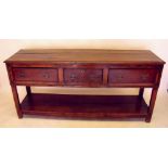 A George III oak and elm low dresser with three drawers over pot board 168 x 44 x 77 cm