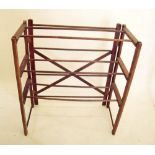 An early 20th century folding wooden towel rail with shelves