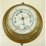 A vintage aneroid circular barometer by John Barker & Co Ltd, Kensington, 28 cm diameter