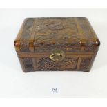 A miniature carved wood oriental box in style of a camphor wood chest decorated with birds etc -