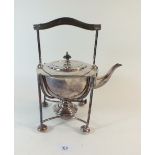 A silver plated tea kettle on stand