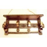 A Flemish early 20th century carved oak hall coat rack and hat shelf with applied copper