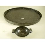 A pewter Arts & Crafts two handled hammered dish and a pewter oval tray embossed with flowers