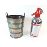 A silver plated champagne bucket 23cm high and a soda siphon