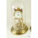 An early 20th century brass torsion pendulum clock under glass dome - 31cm
