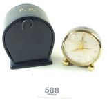 A small eight day travel alarm clock by Looping in its original case