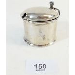 A silver mustard pot with hinged lid inset blue glass liner, London 1906, by Edward Barnard &