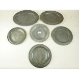 Four eighteenth century pewter plates and two oval platters, many with London and Birmingham touch