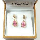 A pair of 9ct gold pendant earrings set pink stones