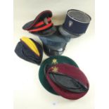 A selection of miscellaneous military and other hats to include a French police Kepi hat, a green