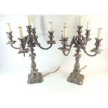 A pair of large silver plated scrollwork five branch candelabra, wired for electricity, 47cm tall