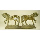 A pair of brass horse form fire dogs