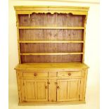 A Victorian pine dresser with display shelves over 2 drawers and a two door cupboard, 146cm wide