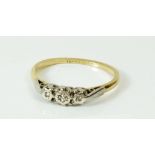 A 9ct gold ring illusion set three chip diamonds, size K/L