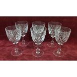A set of six cut glass wine glasses