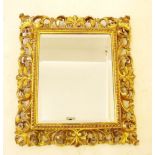 A gilt framed Italian style scrollwork framed mirror, 44 x 39cm