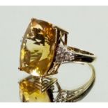 A 9 ct gold ring set citrine on triple diamond set shoulder, size N/O