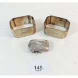 A pair of silver napkin rings and a silver vesta case, Birmingham 1902, Total 78g