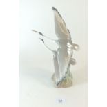 A Nao porcelain figure of flying herons, 27cm