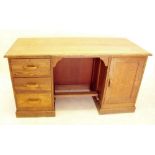 An oak utility desk with three drawers and cupboard designed by Barry Parker and Raymond Unwin