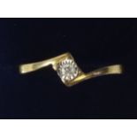 A 9 carat gold cross over ring set diamonds, size P