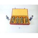 A boxed set of four Chinese painted glass scent bottles and two miniature Chinese figural scent