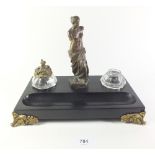 A black slate inkwell with gilt metal mounts and figure of Venus, one inkwell lid missing