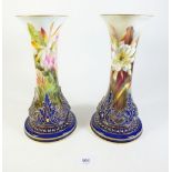 A pair of rare Royal Worcester vases painted tropical flowers within deep blue and gilt borders by