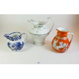 A John Maddock Victorian jug, an early 19th century orange Etruscan style jug and a blue and white