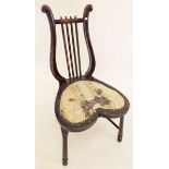 A late 19th century stained beech music chair with heart shaped seat and lyre back