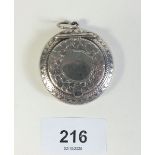 A small silver chatelaine compact with inset mirror and engraved decoration of shamrocks, Birmingham