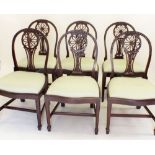 A set of six Hepplewhite style dining chairs with carved decoration