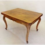 A French 20th century satin walnut draw leaf dining table with carved frieze raised on cabriole