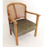 A 1930's cane back tub chair