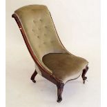 A Victorian mahogany armchair with carved supports and scrollover top